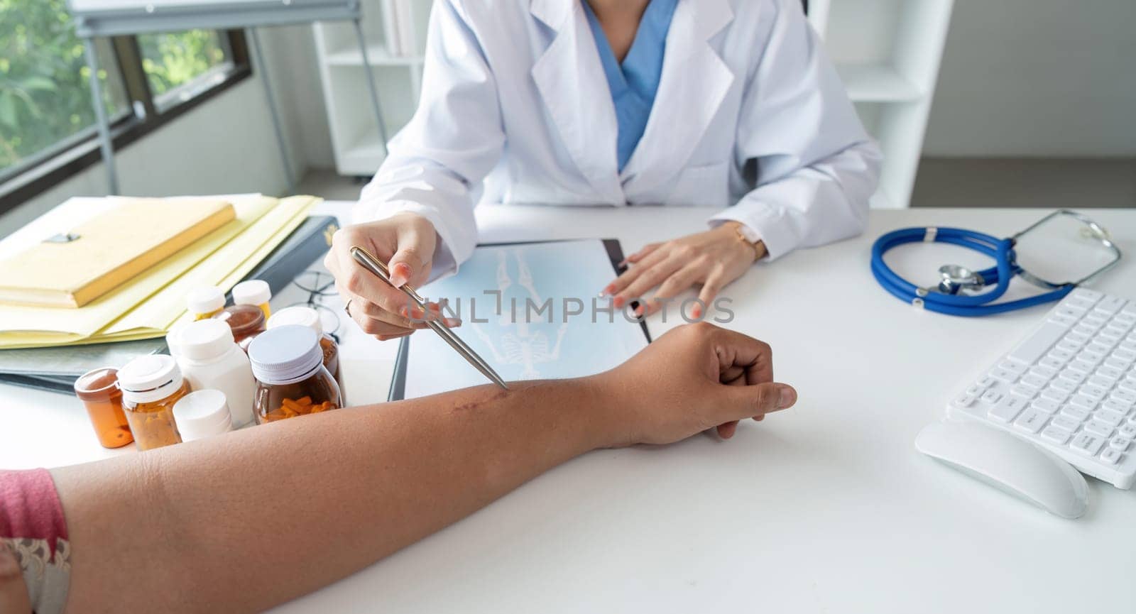 Physician discuss results or symptoms and gives a recommendation to a male patient and signs a medical paper at an appointment visit in the clinic.