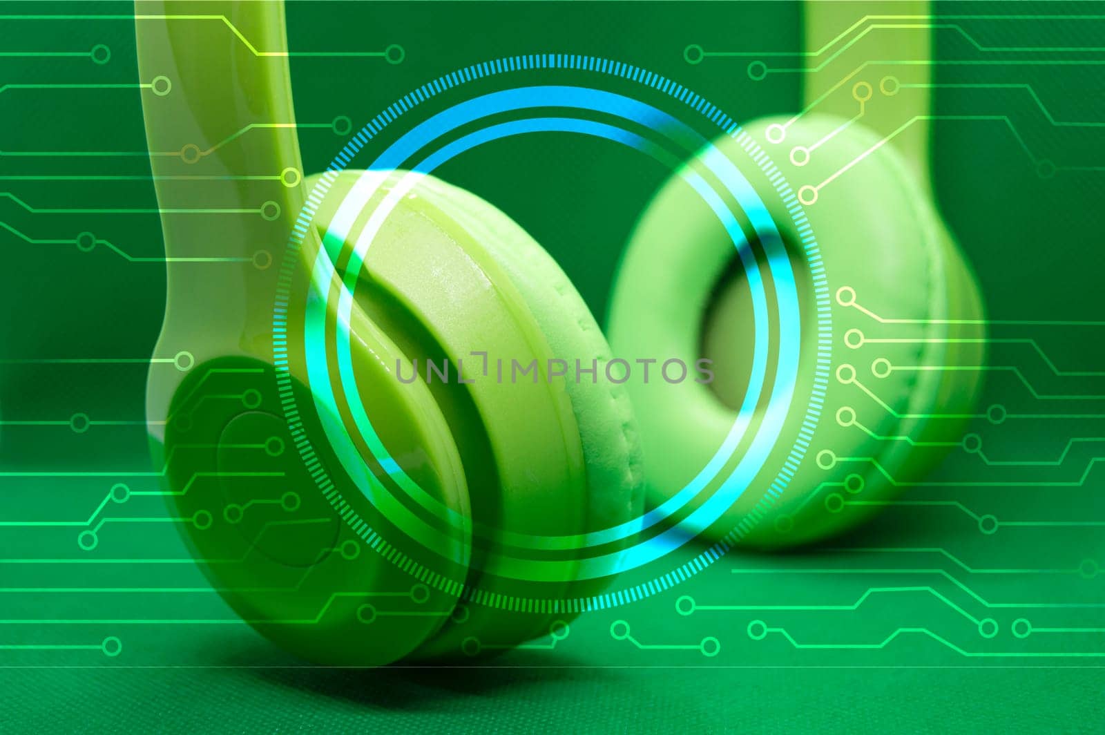 Green headphones isolated from green background