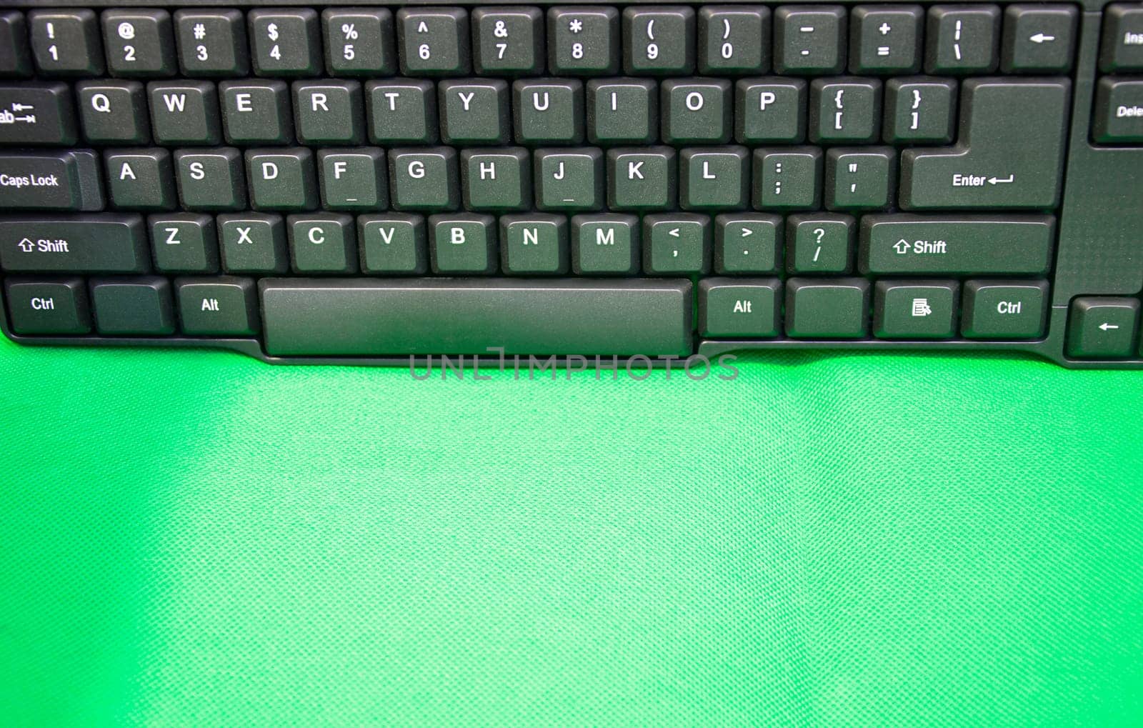front view of keyboard keys placed on a green background