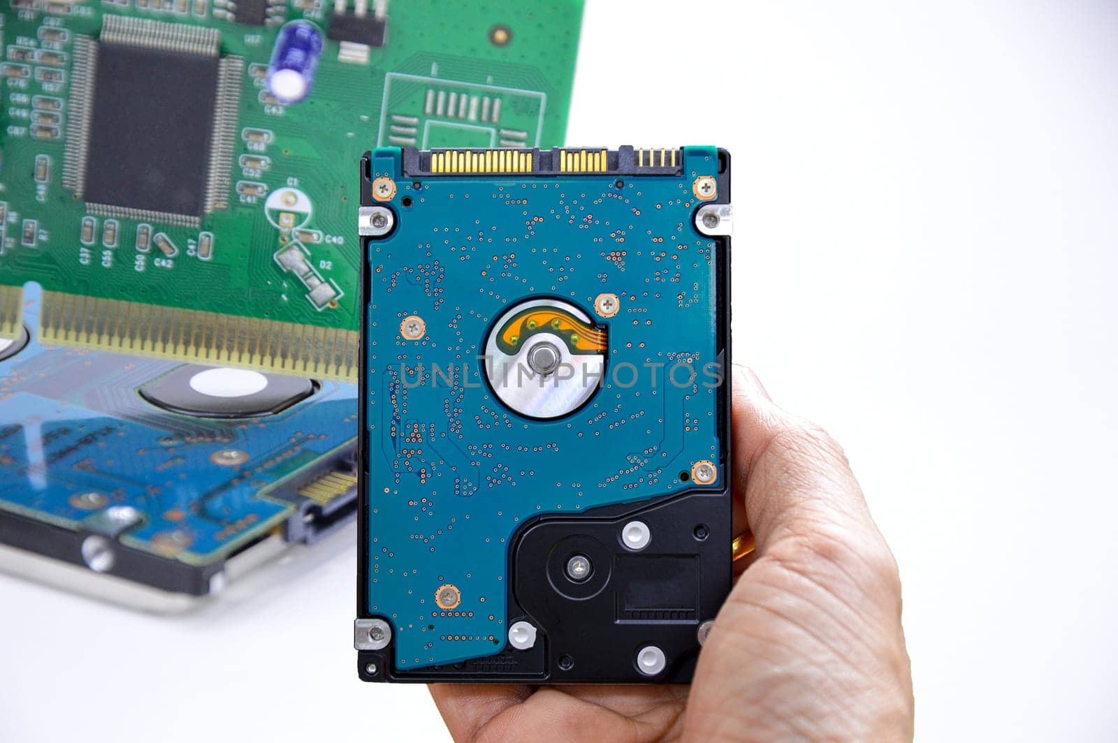 Hard disk drives are still widely used. hard drive in hand (Cut path included in this picture)