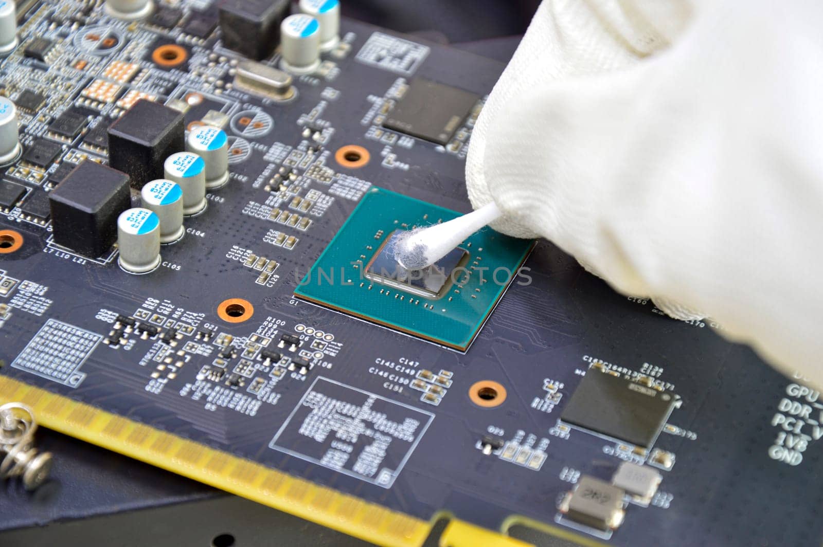 Image of technician cleaning the CPU chip.