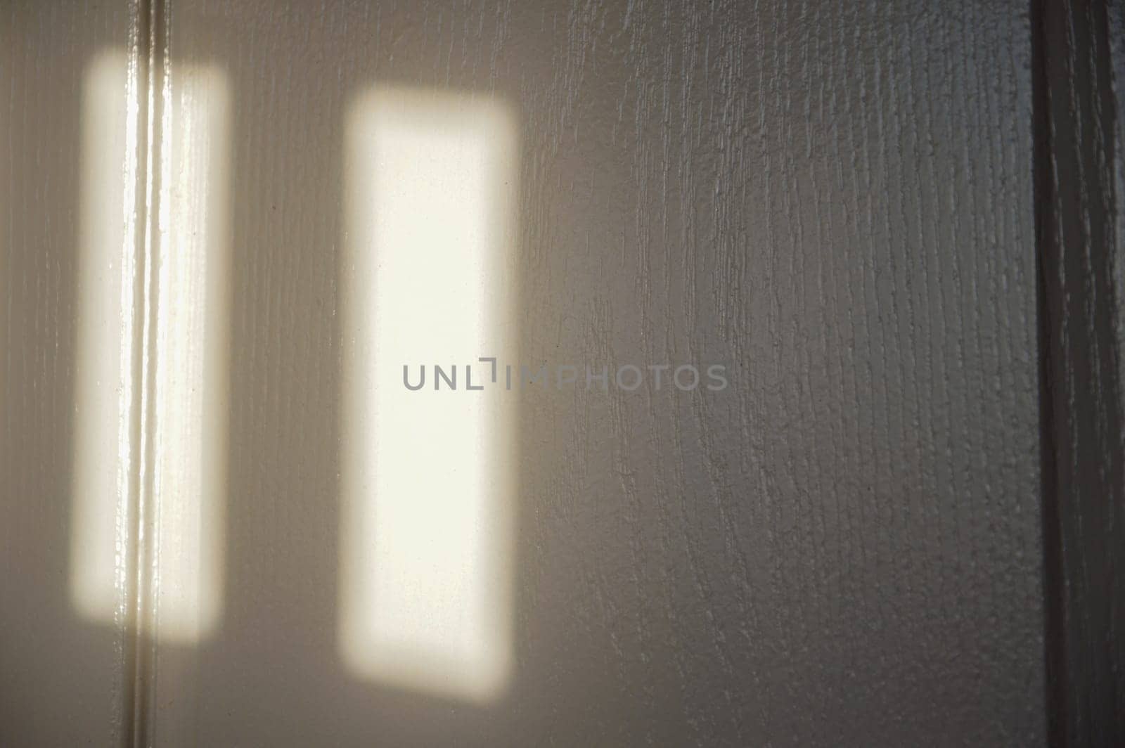 A picture of a wooden wall with red light shining through.