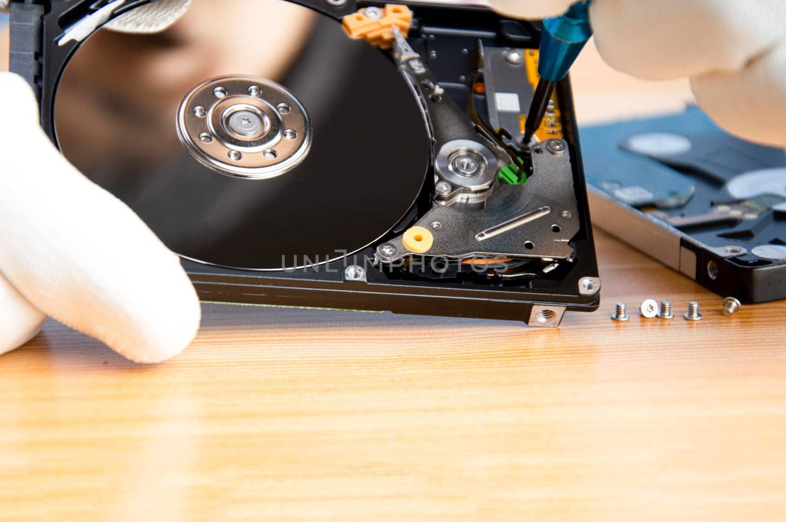 mechanic repairing hard drive, hard drive It is a device for storing data.