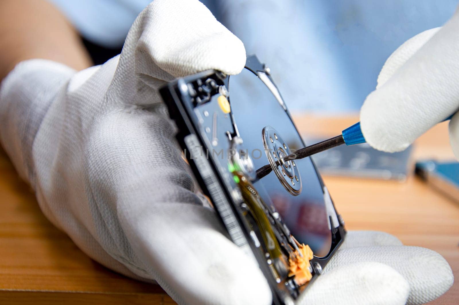 mechanic repairing hard drive, hard drive It is a device for storing data.