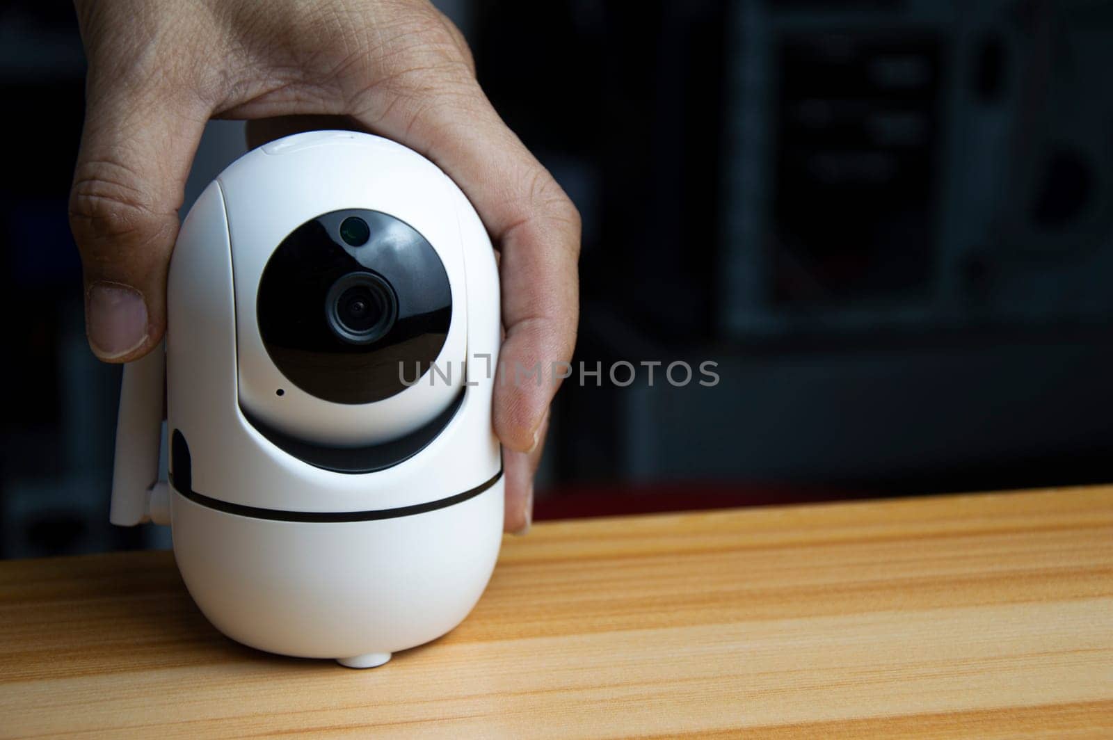 White ip camera lies on wooden floor