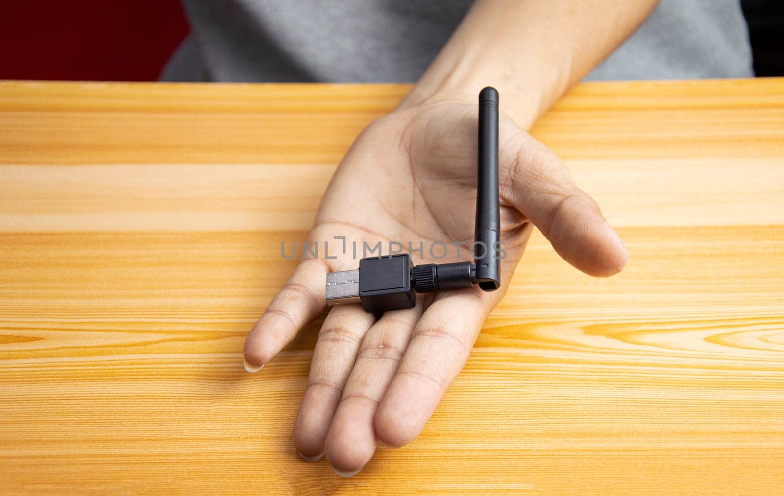 USB wifi black on hand, hand holding usb wifi by boonruen