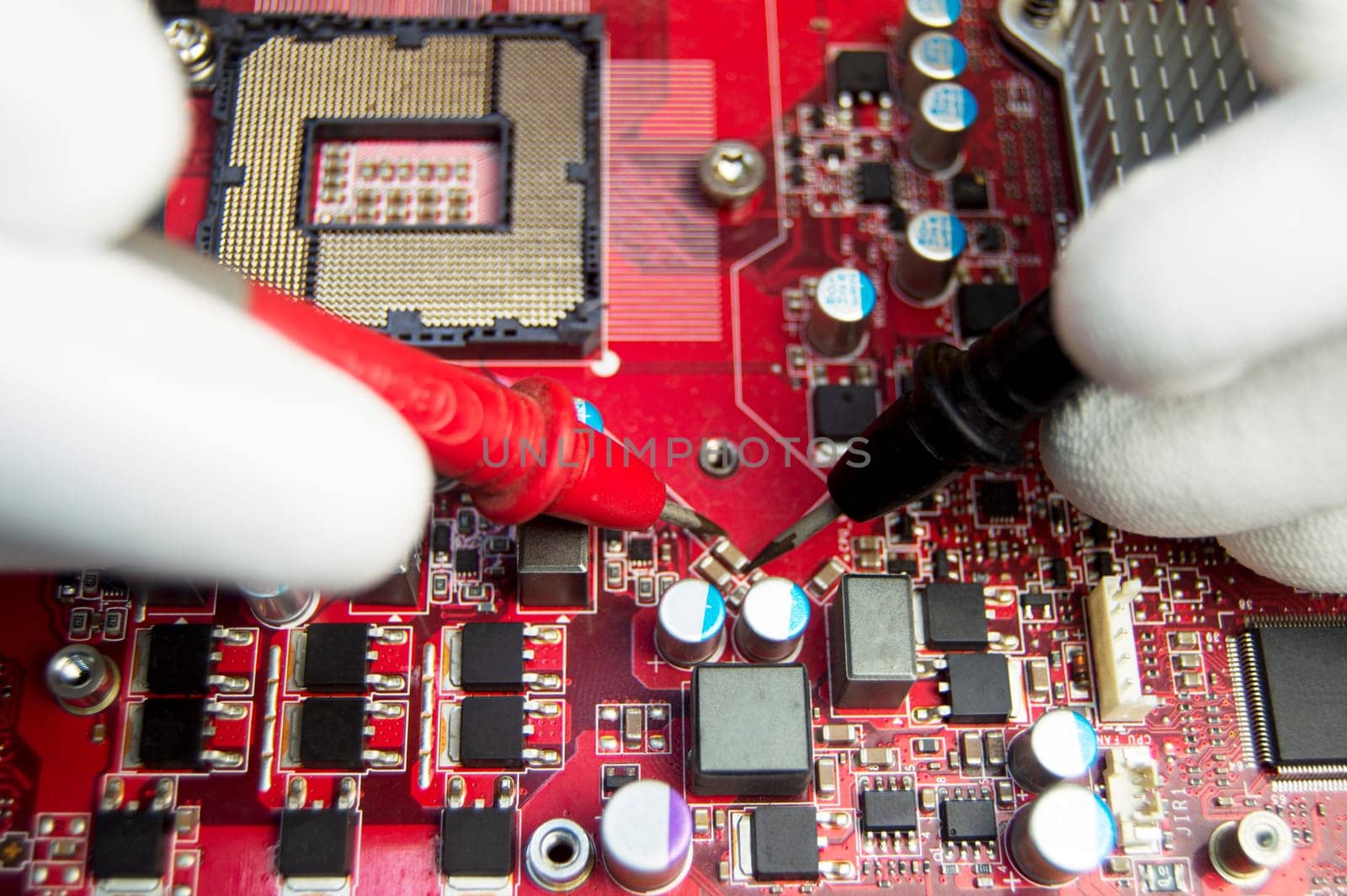 mechanic repairing motherboard, motherboard top view close-up, computer motherboard