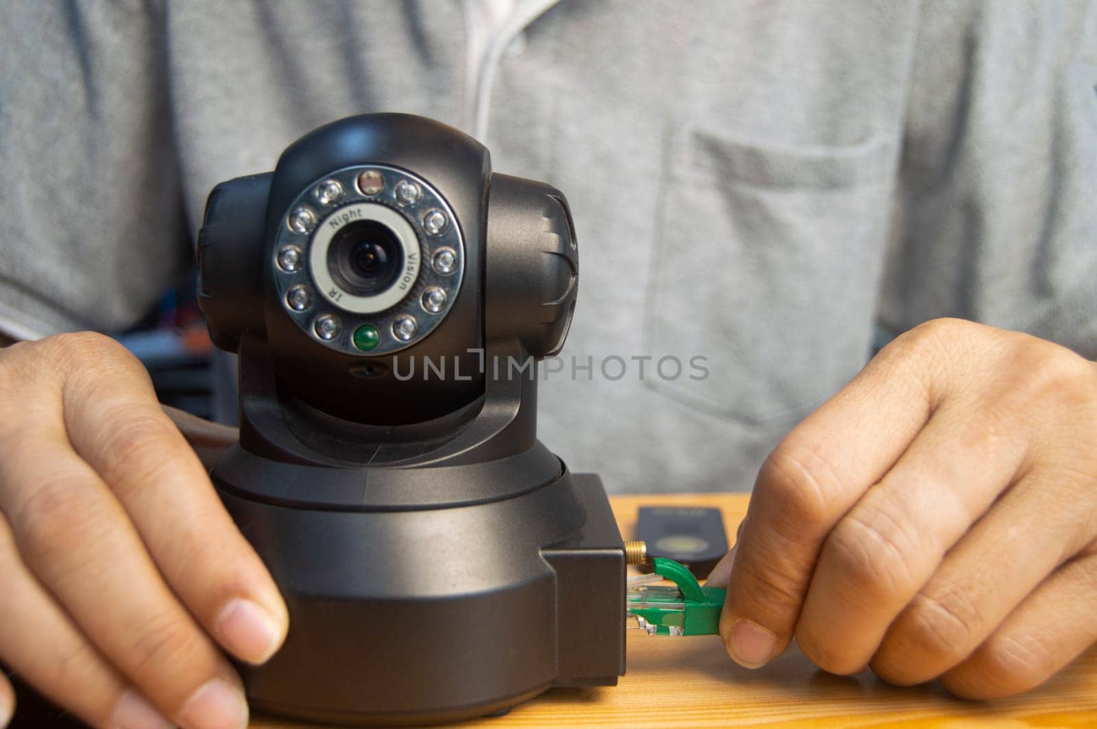 Conceptual man operating ip camera by boonruen