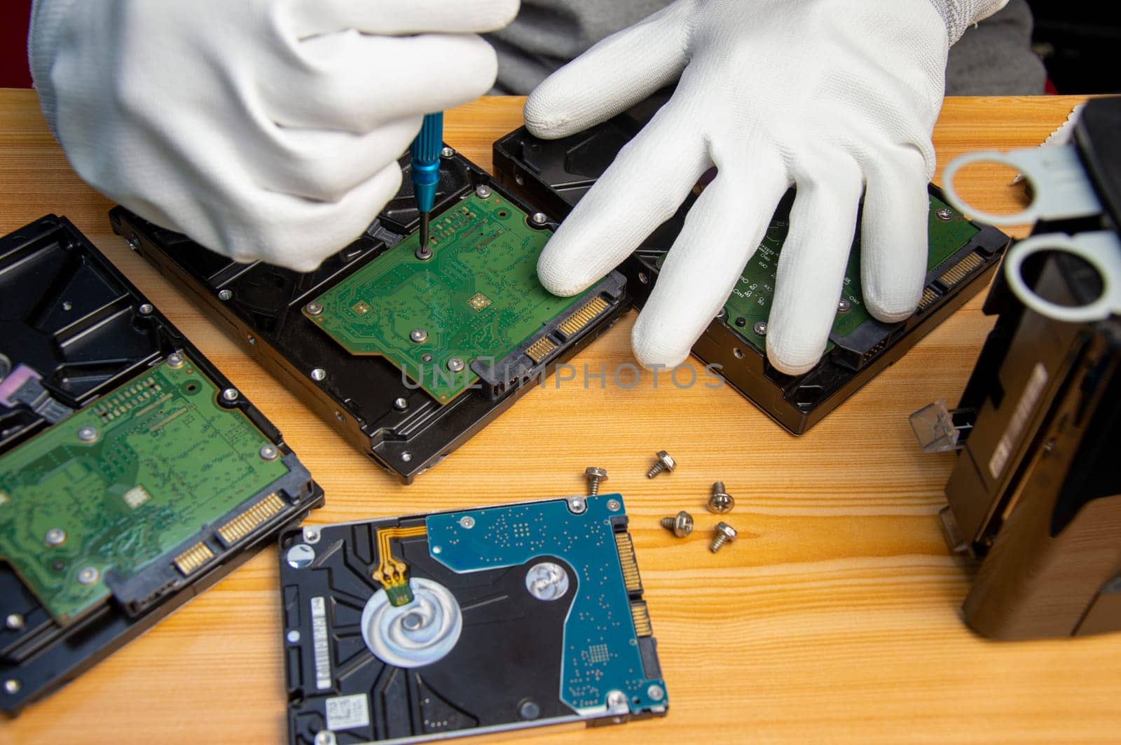 technician is repairing hard drive, hard drive used to store data