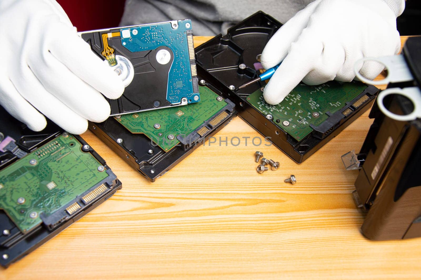 technician is repairing hard drive, hard drive used to store data