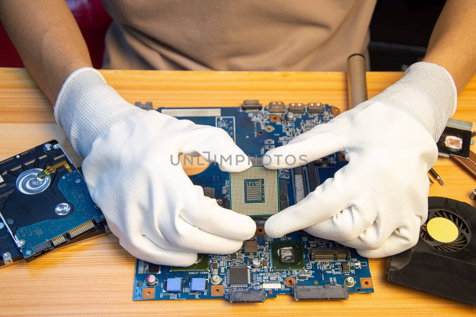 Technician repairing computer motherboard, notebook motherboard by boonruen