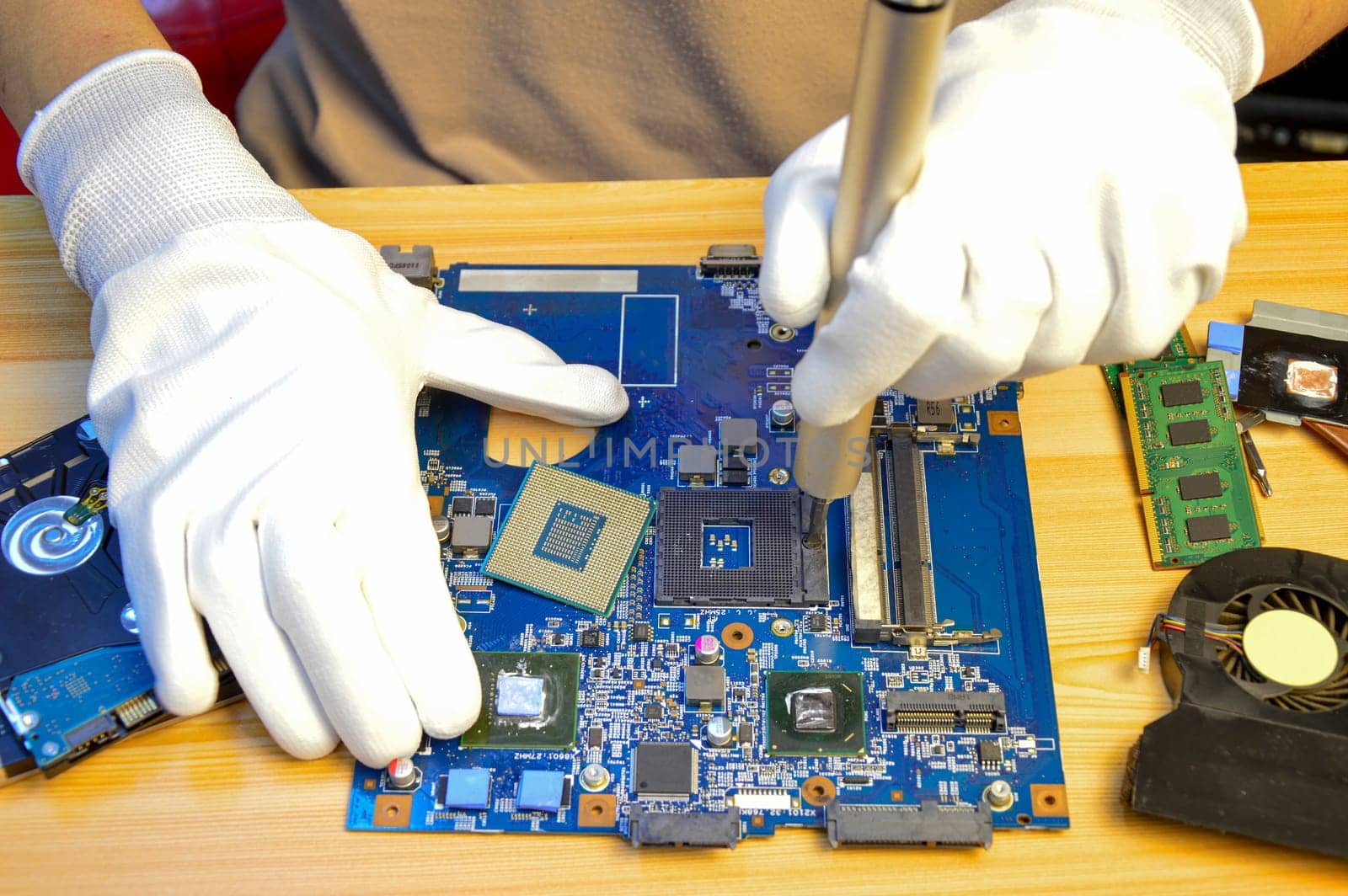 Technician repairing computer motherboard, notebook motherboard