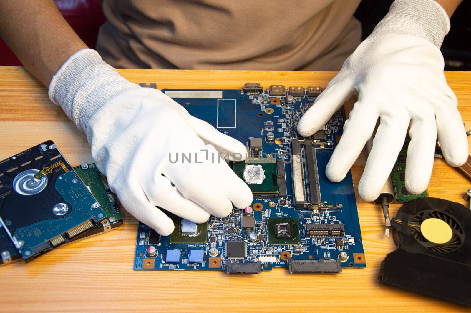 Technician repairing computer motherboard, notebook motherboard