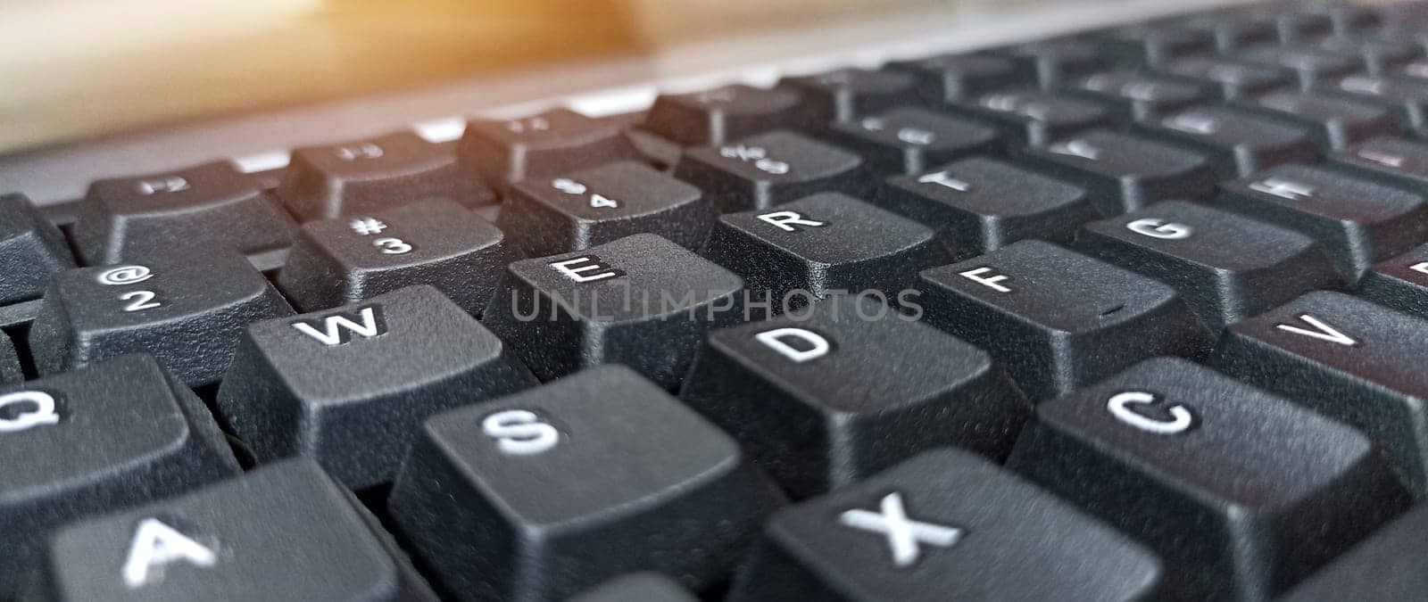 Close-up side view of black keyboard by boonruen