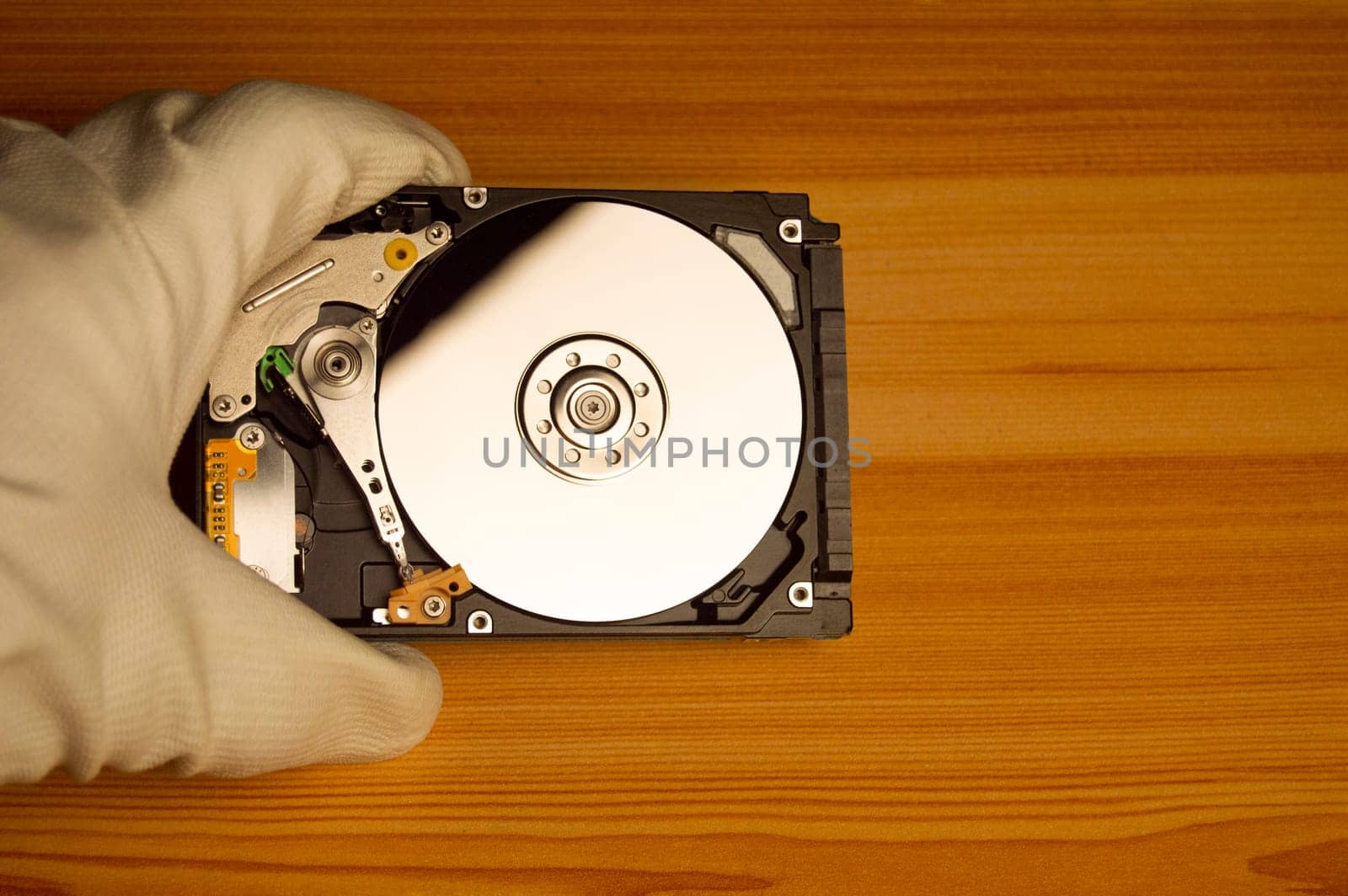 top view mechanic holding hard drive
