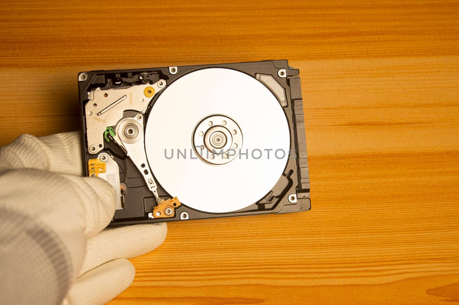 top view mechanic holding hard drive