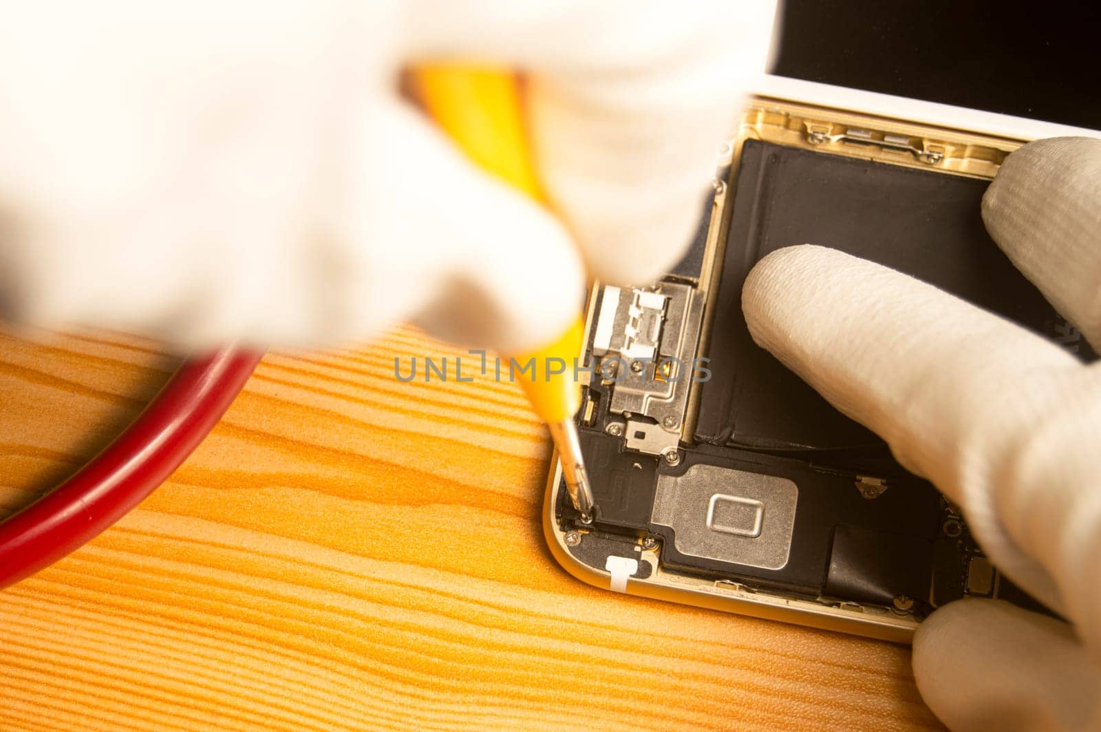 Top view of a technician repairing a smartphone