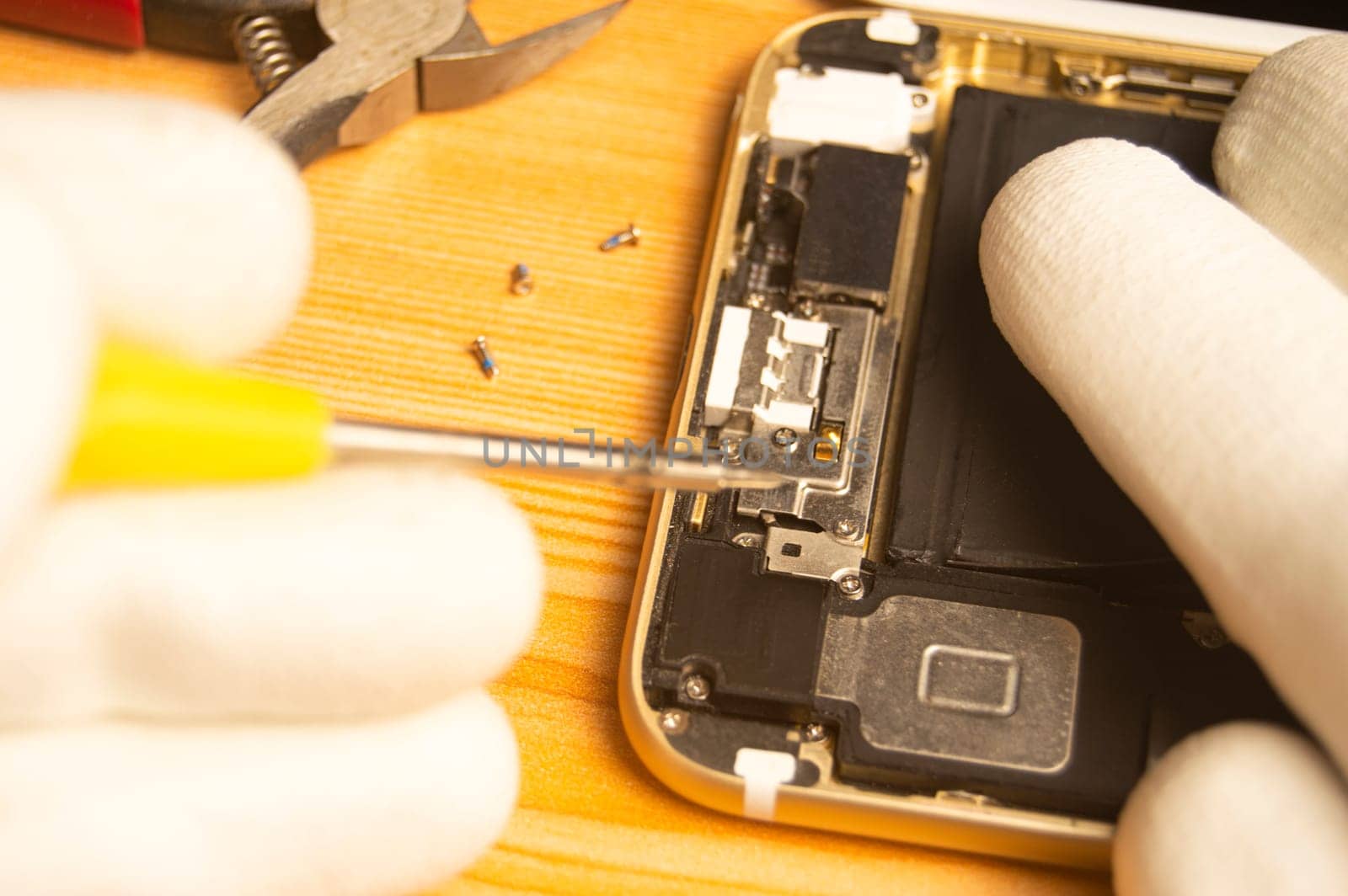 Top view of a technician repairing a smartphone