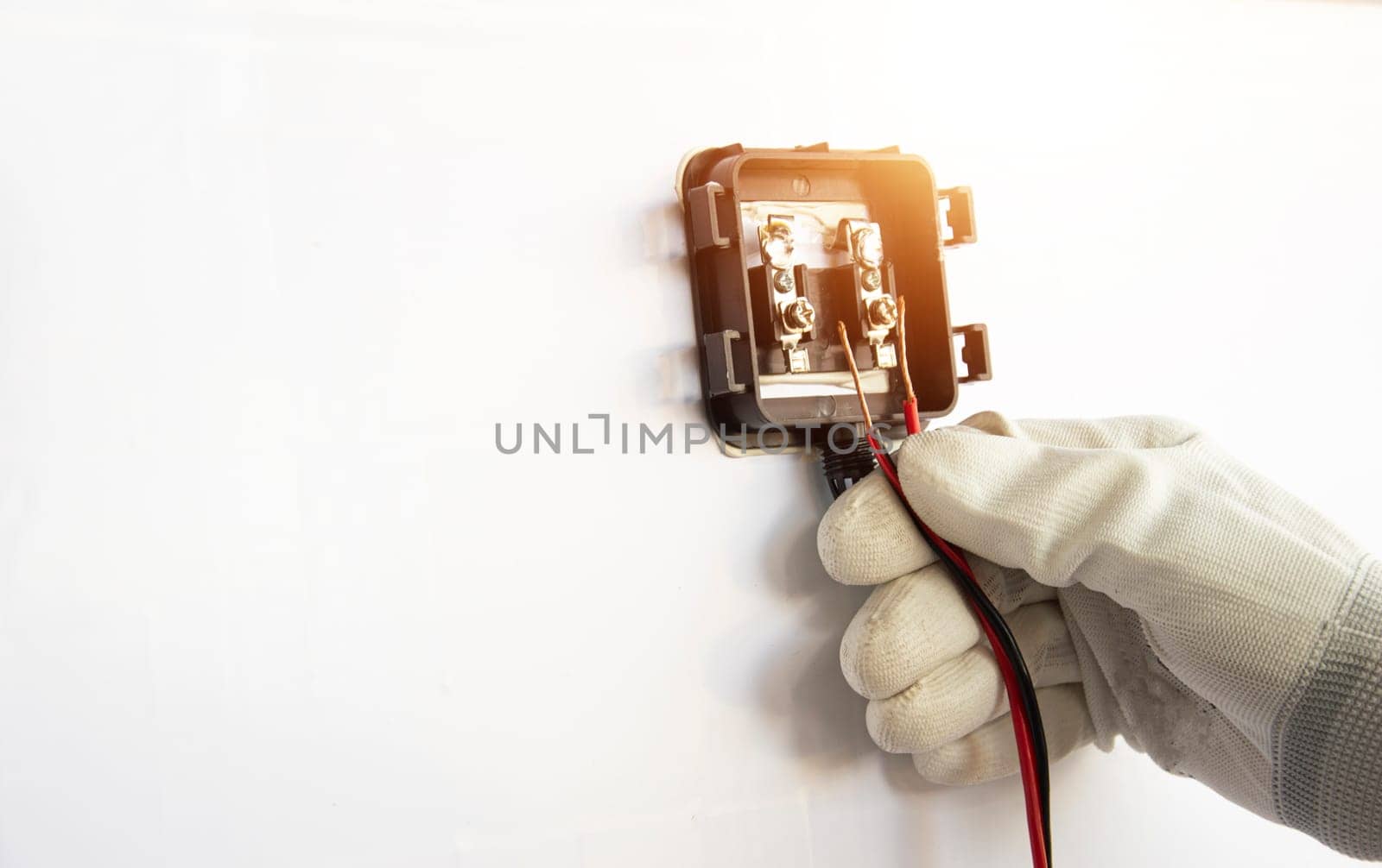 Technicians are connecting wires to solar panels.