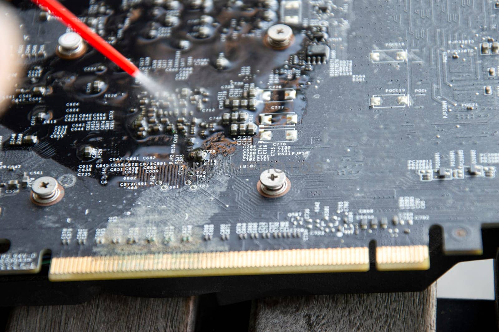 Technician view using spray to clean graphics card by boonruen
