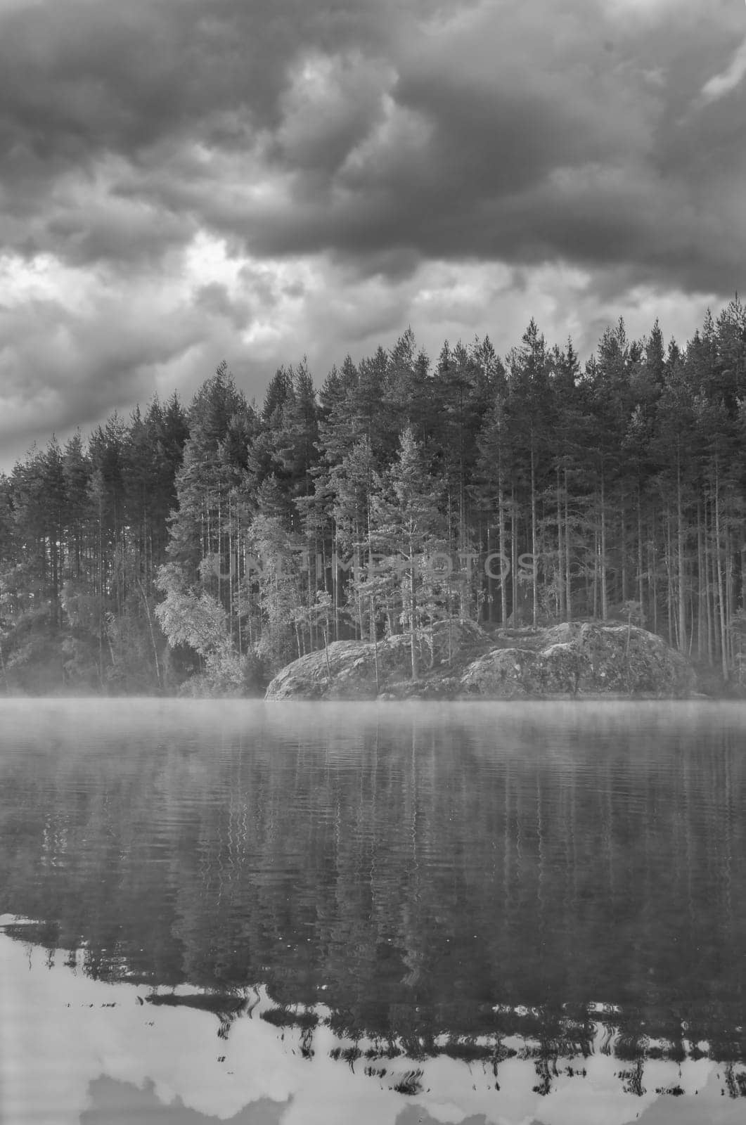 Sunrise with fog forming over a lake in Sweden, at dawn. Romantic silence, in the Scandinavian nature