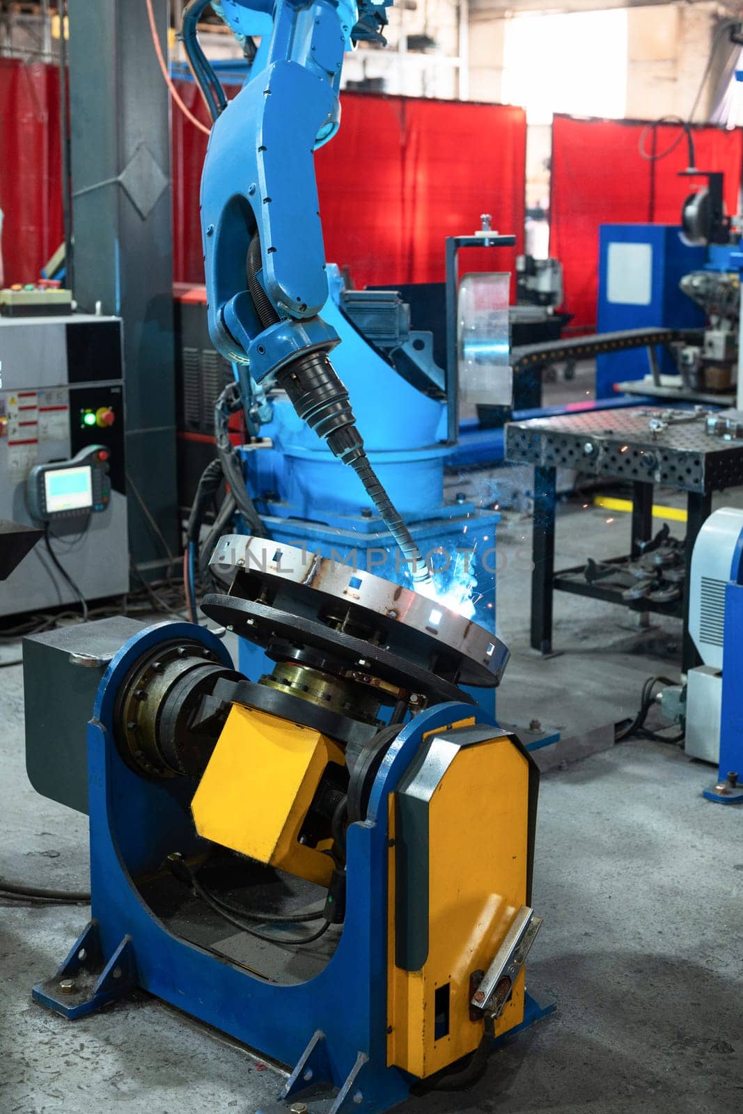 Automatic Industrial welding robot in a modern factory in operation.