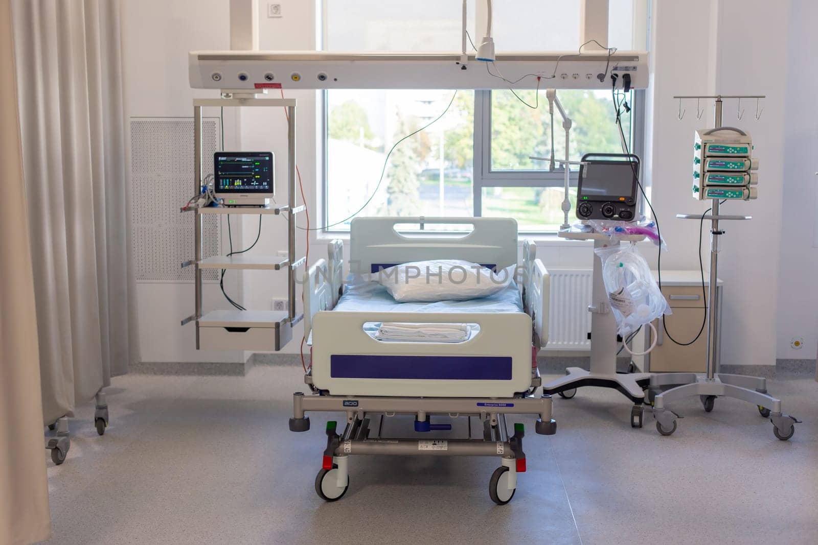 Moscow, Moscow region, Russia - 03.09.2023:An empty, sunlit hospital room with a bed and life-support equipment, showcasing modern medical facilities.