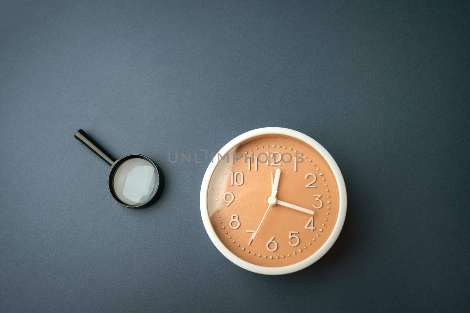 Magnifying glass and clock. Business planning concept. Waiting for a meeting, a date. The cost of hourly work of a specialist. Discussing cases.