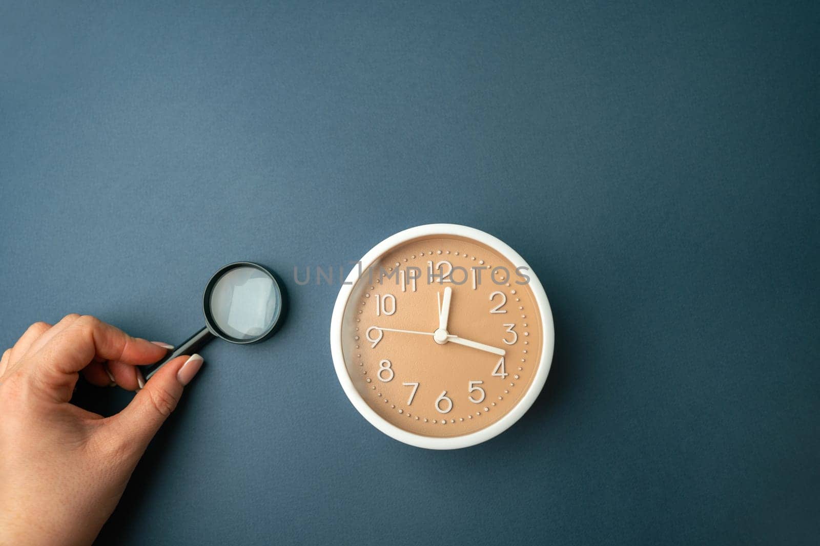 Magnifying glass and clock. Business planning concept. Waiting for a meeting, a date. The cost of hourly work of a specialist. Discussing cases.