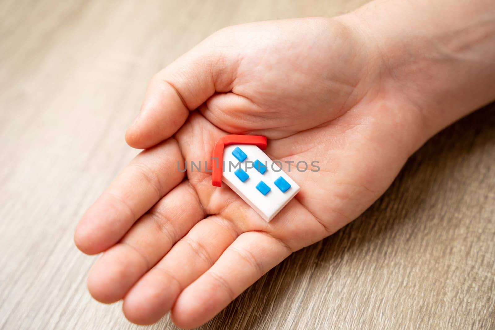 Save your home. Insurance agent protects the house with a gesture of protection. Security and safety in the home. Life insurance and family. Achieving peace of mind. Attention and care.