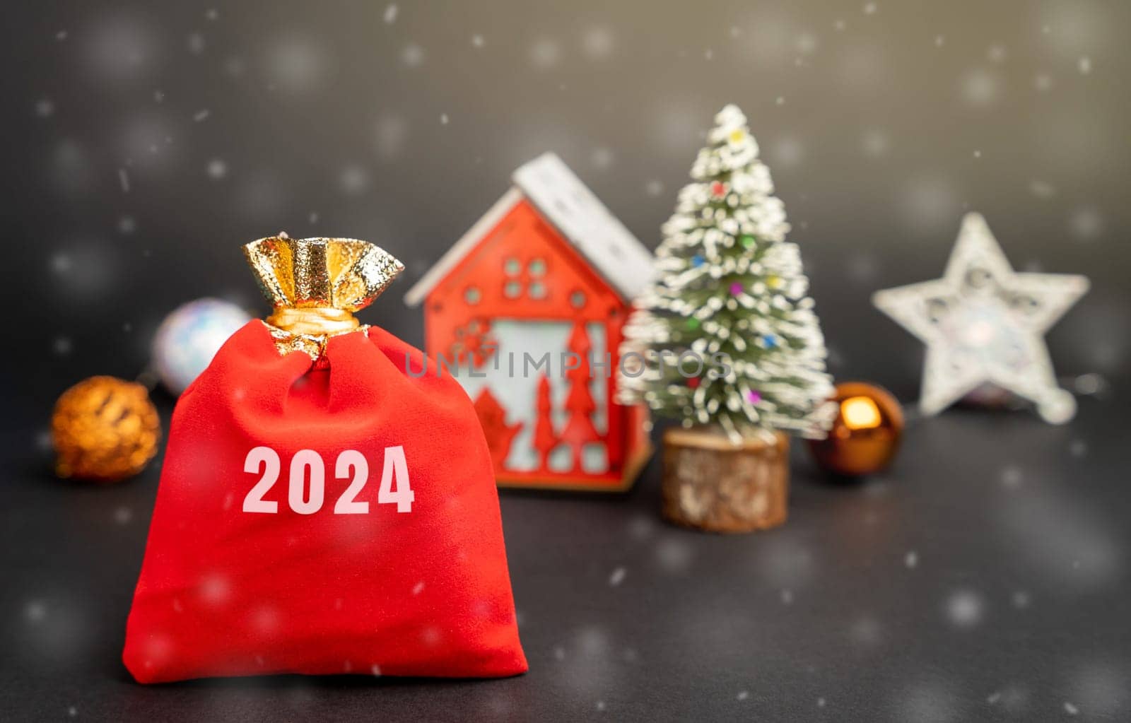 Gifts bag 2024 with house and Christmas tree. Happy New Year and Merry christmas! Decoration, celebration. The concept of the beginning of the new year. Snow, snowfall