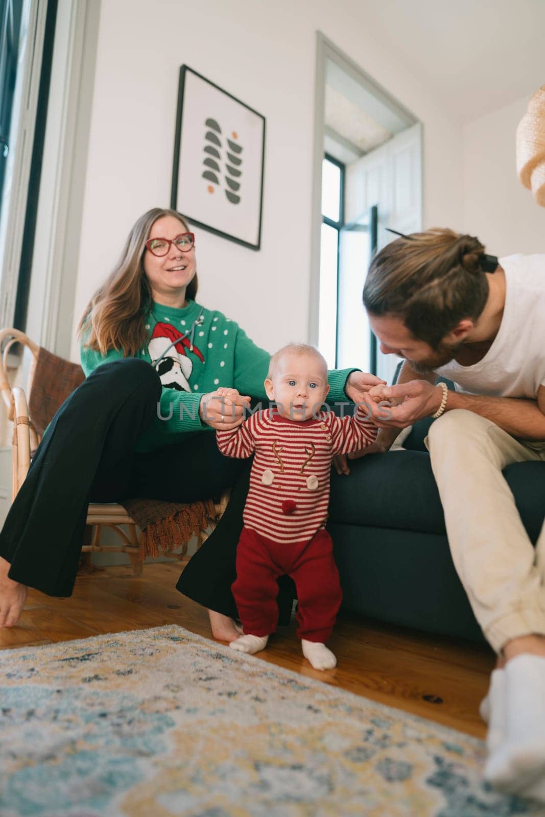 A joyful family scene with laughter celebrating the holidays together, featuring a happy baby in a cozy setting