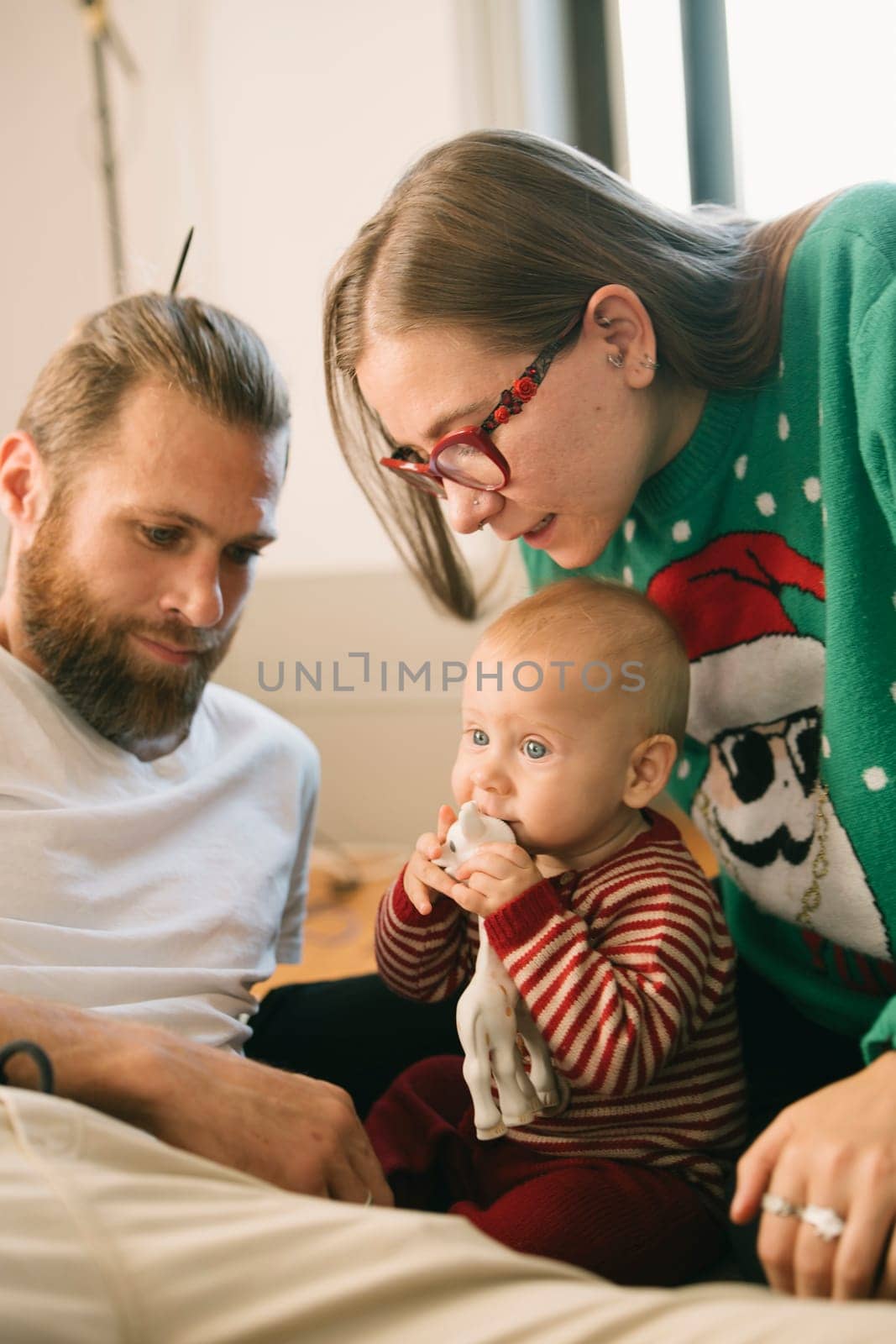A heartwarming moment of family bonding with a happy baby and loving parents celebrating joy together