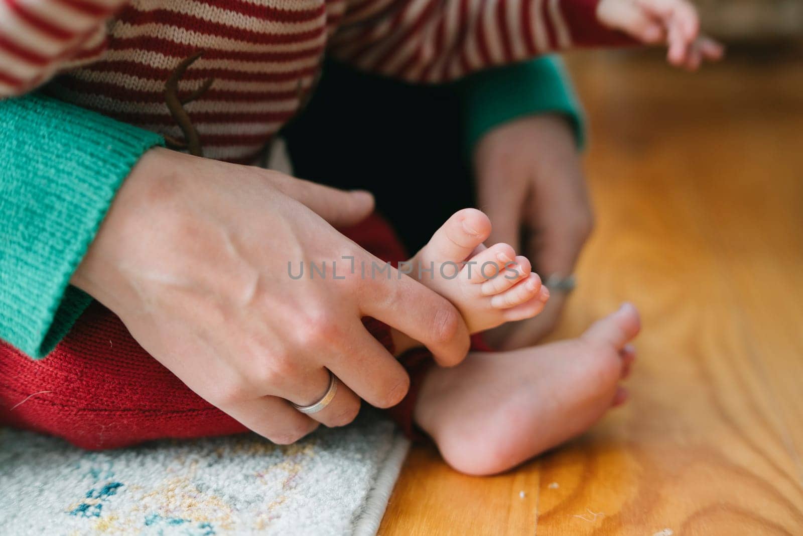 A heartwarming and tender scene beautifully showcasing a loving parent gently holding their childs tiny foot