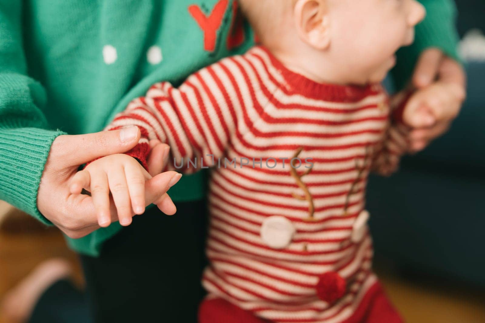 A heartwarming moment showcasing festive attire and the precious bond between a caregiver and a baby