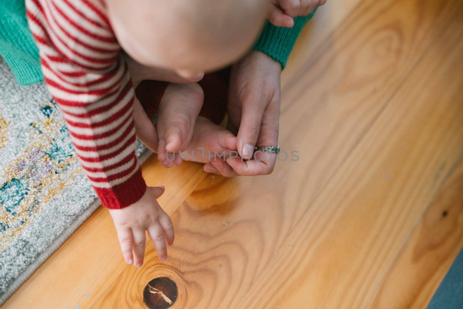 A heartwarming moment shows a parent engaging with their baby, exploring different textures together