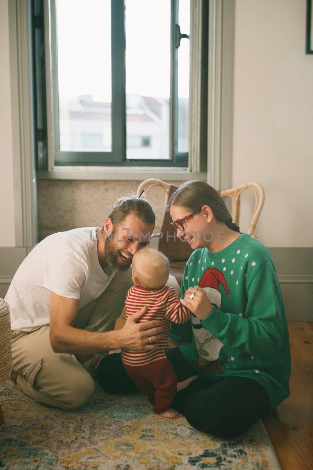 A heartwarming family bonding session featuring a delightful baby, joyfully celebrating love and togetherness