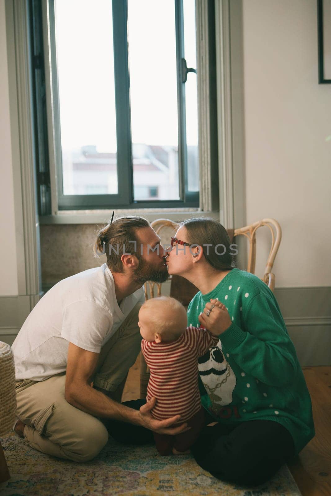 A heartwarming family scene beautifully showcasing the tender affection shared between loving parents and their baby