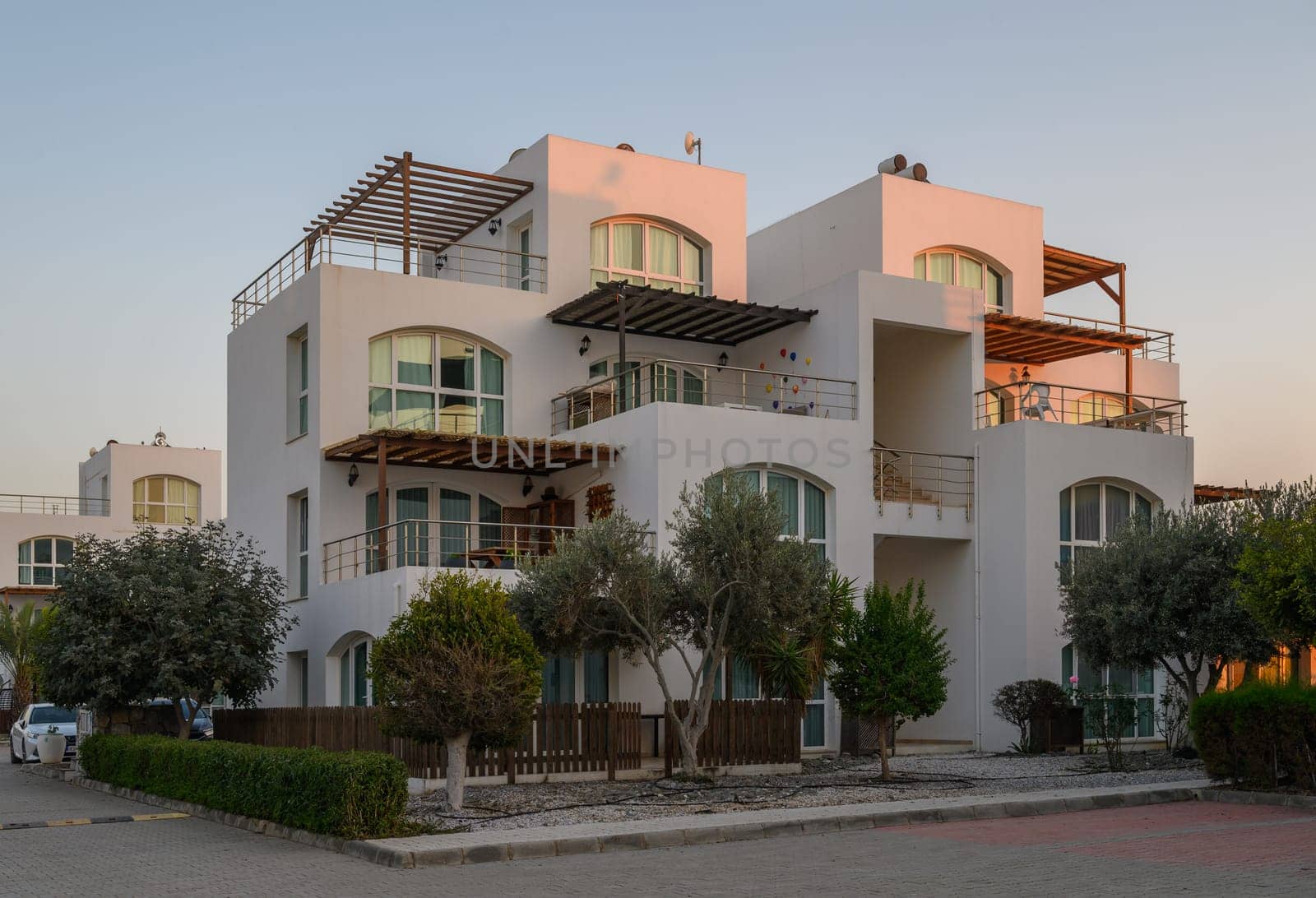 Elegant architecture stands prominently against a soft dusk sky, inviting tranquility and charm to the neighborhood.