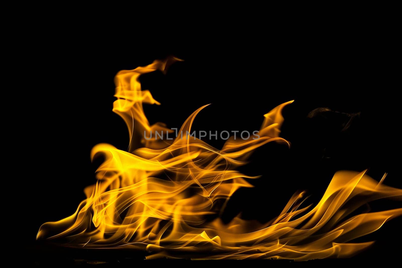 Abstract flames on black background in dynamic motion.