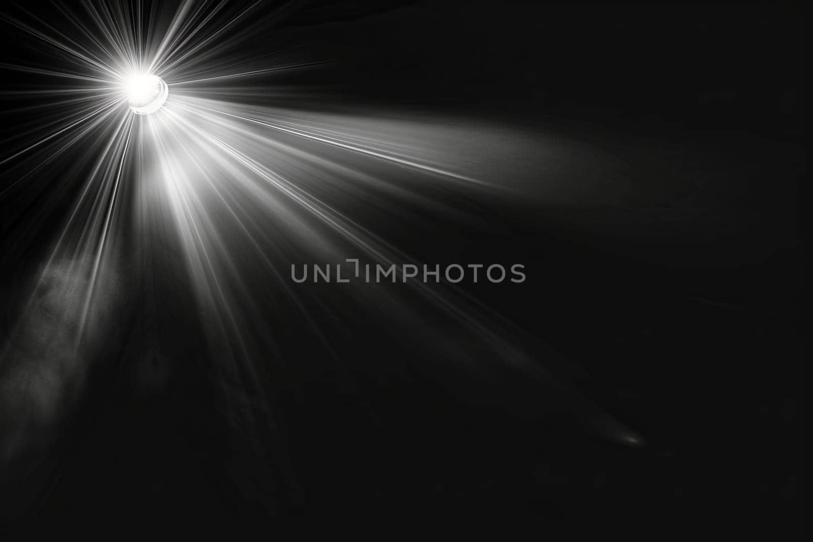 Bright spotlight illuminating darkness with radiating light beams.