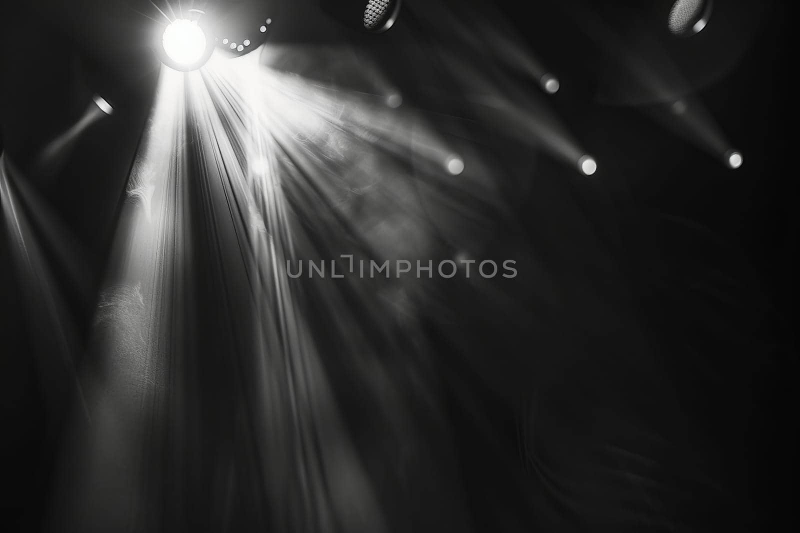 Dramatic stage lighting with intense beams and shadows.