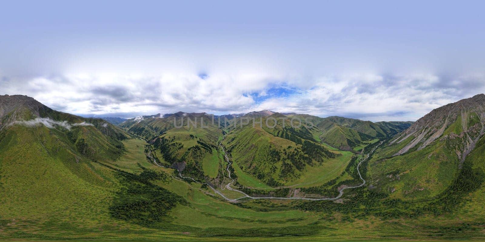 360 panorama of a mountainous area from a height. Drone view of green meadows and hills, with coniferous trees in places. A river runs through the forest. White clouds and blue sky. Beautiful gorge.