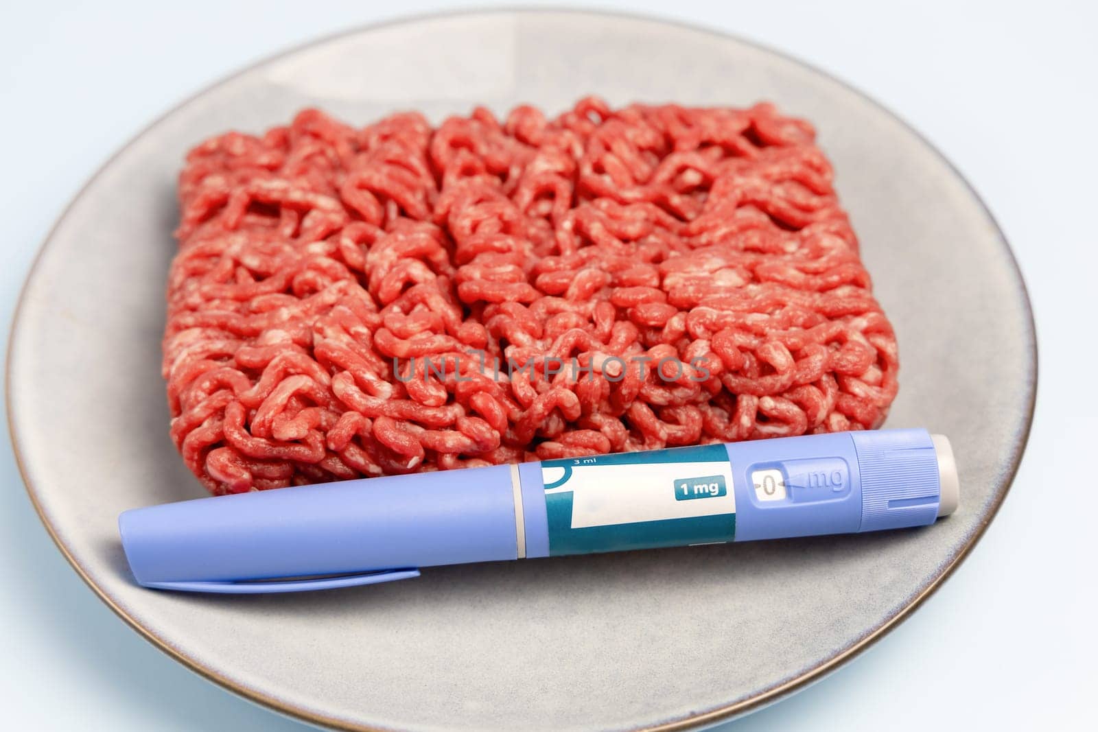 Ozempic Insulin injection pen and raw minced meat for diabetics and weight loss. High quality photo