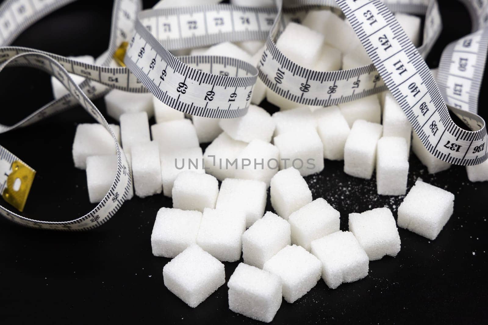 Cubes of white refined sugar on a black background. High quality photo