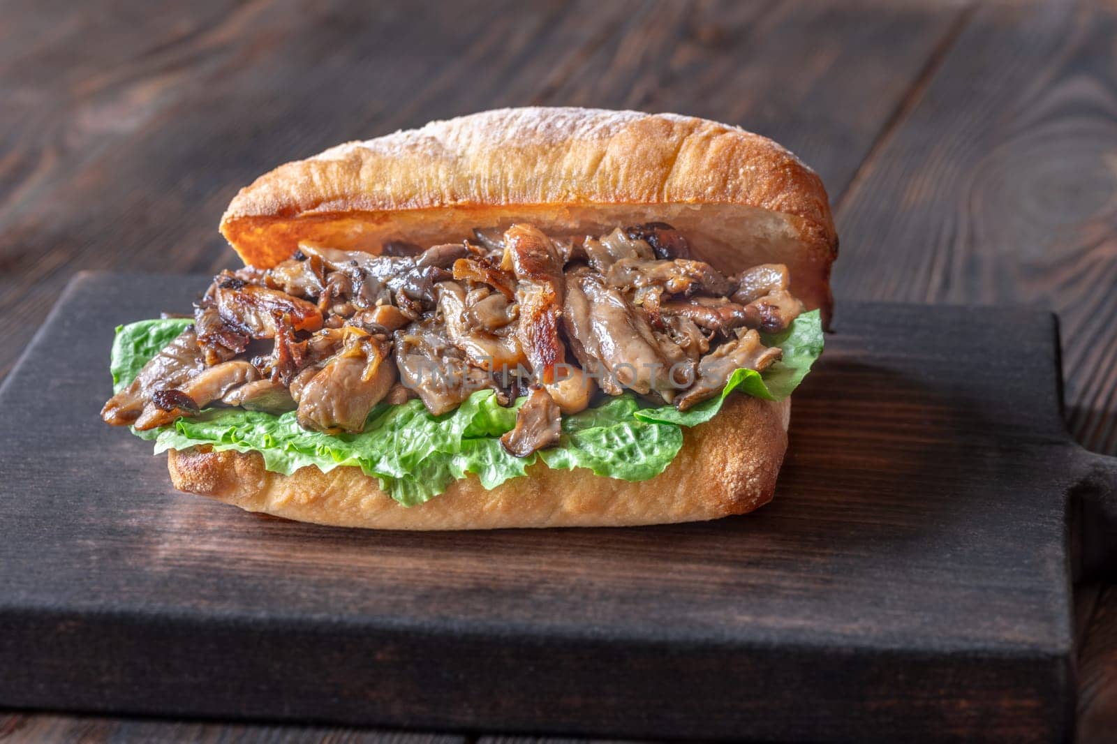 Delicious vegetarian sandwich with toasted ciabatta, fried oyster mushrooms, and yellow sauce