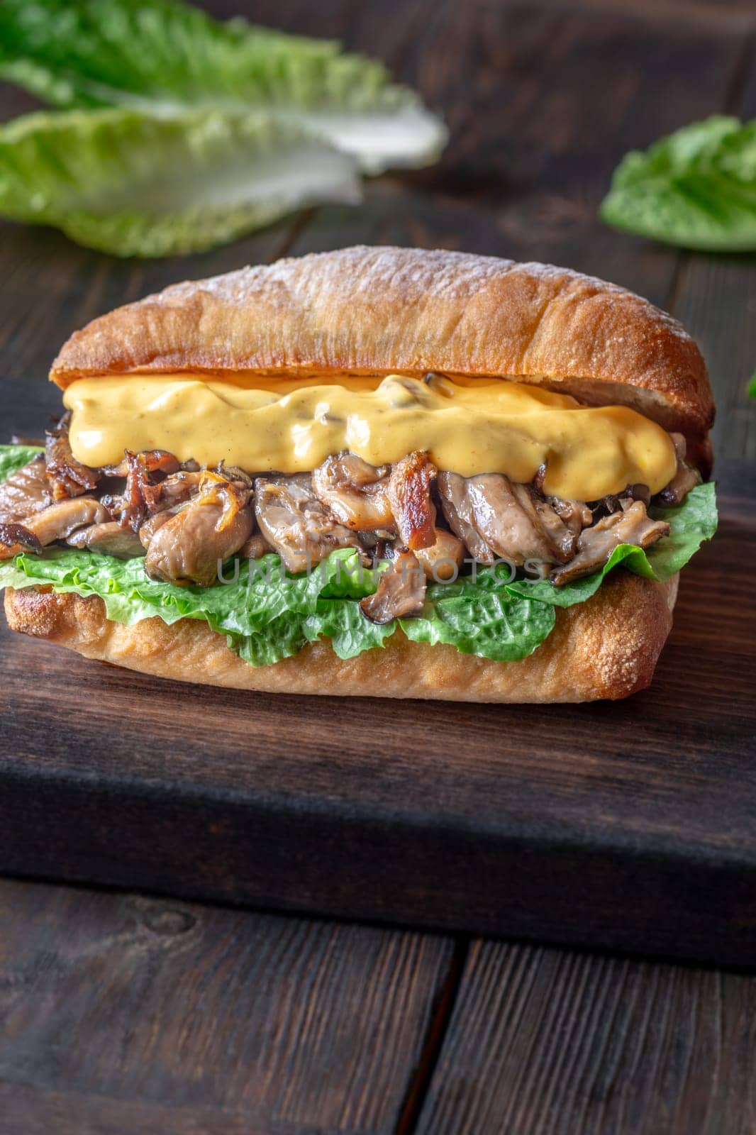 Delicious vegetarian sandwich with toasted ciabatta, fried oyster mushrooms, and yellow sauce