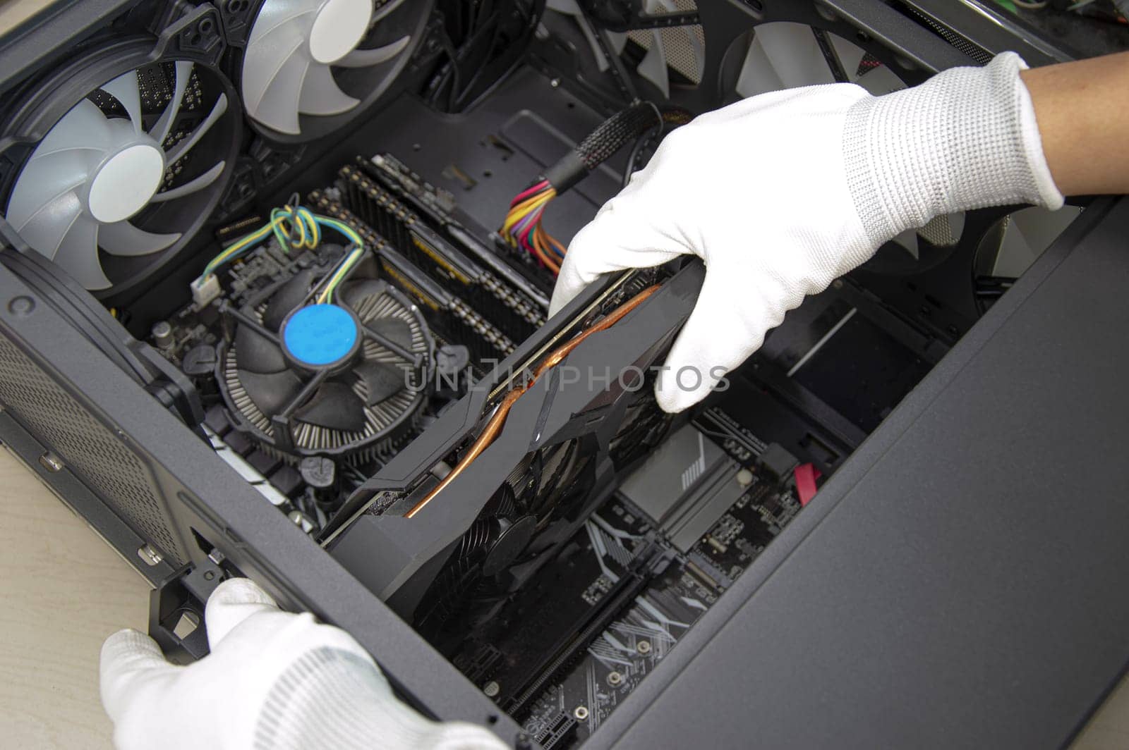 top view mechanic installing graphics card by boonruen