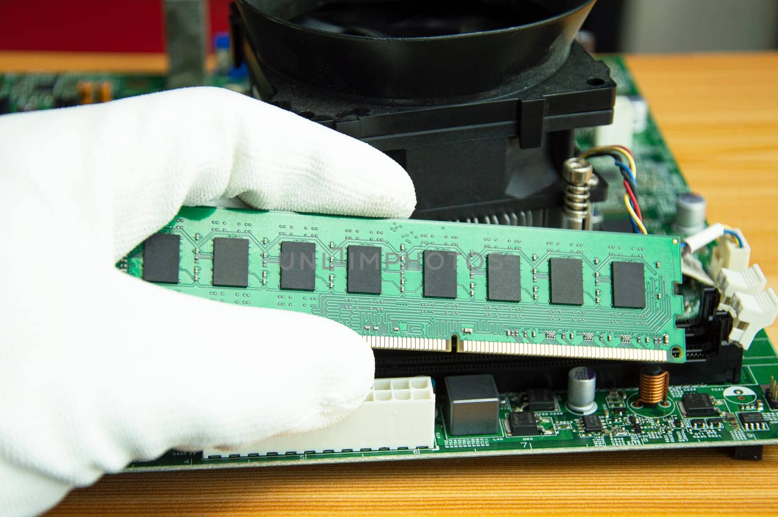 side view mechanic holding ram of the computer motherboard