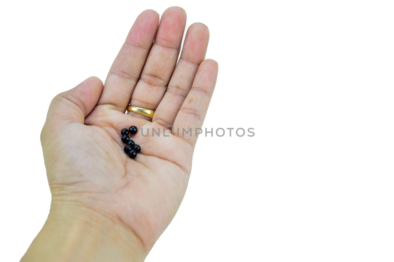 A hand with a pill on it, with clipping path